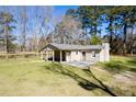 Exterior view of back of house with spacious yard and a partially covered patio space at 328 Fox Field Rd, Walterboro, SC 29488