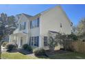 Well-maintained two-story home exhibiting vinyl siding, a manicured lawn, and bright blue shutters at 329 Carriage Wheel Rd, Moncks Corner, SC 29461