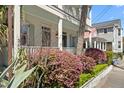 Beautiful two-story home with a porch, and lush landscaping featuring vibrant bushes, adding charm and curb appeal at 382 Race St # A, Charleston, SC 29403