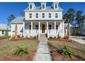 Stunning two-story home with a welcoming front porch, beautiful landscaping, and a charming walkway at 3889 Summerton St, Mount Pleasant, SC 29466