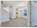 Bright dining room with a modern chandelier and wood-look flooring at 462 Fox Sparrow Ct, Summerville, SC 29486