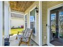 Relaxing front porch featuring a wooden rocking chair and a beadboard ceiling at 587 Crossland Dr, Moncks Corner, SC 29461