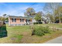 Cozy one-story home with a quaint front porch in a quiet neighborhood setting at 679 Kent St, Mount Pleasant, SC 29464