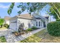 Charming single-story home features light gray siding, well-manicured landscaping, a two-car garage, and a welcoming entrance at 102 Harbor Point Ct, Summerville, SC 29486