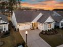 Charming home featuring a three-car garage, well-manicured lawn, and inviting curb appeal at 105 Bluff Isle Ct, Summerville, SC 29486