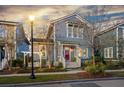 Two-story home featuring a red front door, white trim, and a swing in the landscaped yard at 107 Nutmeg Way, Summerville, SC 29485