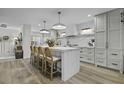 Bright kitchen with a large island, pendant lighting, marble countertops, and seating for four at 1103 Ventura Pl, Mount Pleasant, SC 29464