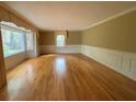 Bright living room with hardwood floors, large windows, and classic trim, offering a cozy and inviting space at 116 W Johnston St, Summerville, SC 29483