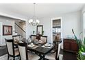 Well-lit dining room featuring a dark wood table and a view into the modern kitchen at 123 Hewitt St, Summerville, SC 29486