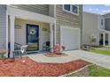 Cozy porch with seating, stylish wreath, and charming landscaping in a pleasant setting at 124 Gaura Ln, Summerville, SC 29483