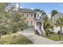 Elegant two-story home with well-maintained landscaping and an inviting staircase leading to the front door at 1428 Bloomingdale Ln, Mount Pleasant, SC 29466