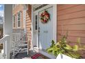 Inviting front entrance with a decorative wreath, a chair, and charming details on the porch at 1428 Bloomingdale Ln, Mount Pleasant, SC 29466