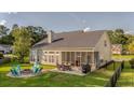 Spacious backyard featuring a screened porch, patio, fire pit, and lush lawn perfect for outdoor living at 144 Back Tee Cir, Summerville, SC 29485
