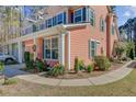A charming suburban home, showcasing its unique color scheme and professionally landscaped yard with blooming plants at 1807 Chauncy'S Ct, Mount Pleasant, SC 29466