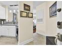 Bright hallway leading to an open kitchen with stainless steel appliances and modern backsplash at 1919 Basildon Rd, Mount Pleasant, SC 29466