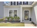 Inviting front entrance featuring a modern glass door, manicured landscaping, and home address at 203 Hayworth Rd, Summerville, SC 29486