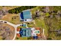 Aerial shot showcases a well-maintained home with a pool, detached garage, and meticulously landscaped surroundings at 212 Chester Ln, Cottageville, SC 29435