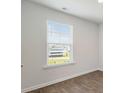 A cozy room with wood flooring, a double-hung window with blinds, and white walls with baseboard trim at 2250 Macallan Blvd, Ravenel, SC 29470