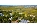 Breathtaking aerial view of luxury homes nestled among lush greenery and winding waterways at 2314 Goldbug Ave, Sullivans Island, SC 29482