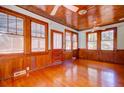 Inviting living room with hardwood floors, wood-paneled walls, and an abundance of natural light at 2314 Goldbug Ave, Sullivans Island, SC 29482