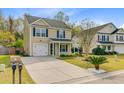 Inviting home with a well-kept lawn, neat landscaping, and a convenient driveway at 236 Emerald Isle Dr, Moncks Corner, SC 29461