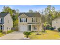 Lovely home with a manicured lawn, simple landscaping, and a practical driveway at 236 Emerald Isle Dr, Moncks Corner, SC 29461
