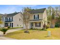 Quaint two-story home with tidy landscaping and a cozy front porch at 236 Emerald Isle Dr, Moncks Corner, SC 29461
