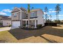 Lovely two-story home with a well-manicured lawn and a two-car garage on a beautiful day at 261 Celestial Blvd, Summerville, SC 29486