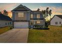 Beautiful two-story home with stone accents, a two-car garage, and a well-maintained front yard at 261 Celestial Blvd, Summerville, SC 29486