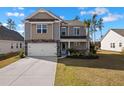 Beautiful two-story home with stone accents, a two-car garage, and a well-maintained front yard at 261 Celestial Blvd, Summerville, SC 29486