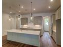 Modern kitchen featuring a large island with quartz countertops and stainless steel appliances at 2950 Lodge Berry Ln, Johns Island, SC 29455