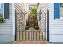 Ornate wrought iron gate leading to a private courtyard and beautifully maintained property at 3 Atlantic St, Charleston, SC 29401
