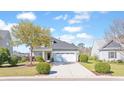 Inviting two-story home with lush landscaping, a wide driveway, and a classic suburban appeal at 3016 Adventure Way, Ladson, SC 29456