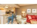 Charming living space with a breakfast bar that connects to a well-equipped kitchen area at 302 Palmetto Dr # A-302, Isle of Palms, SC 29451