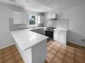Bright kitchen featuring stone countertops, white cabinets, and modern appliances at 3048 Queensgate Way, Mount Pleasant, SC 29466