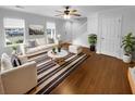 Bright living room featuring wood floors, natural light and stylish decor at 3048 Queensgate Way, Mount Pleasant, SC 29466