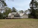 Expansive backyard with a large deck, screened-in porch, and plenty of space for outdoor activities at 4 Fairway Ct, Walterboro, SC 29488