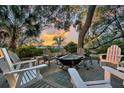 Inviting outdoor fire pit surrounded by comfortable seating with gorgeous trees and nature all around at 4247 Faber Place Dr # 5103, North Charleston, SC 29405