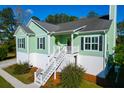 Charming elevated home with stairs to entry, a welcoming porch, and dark shutters at 4281 Jacobs Point Ct, Ravenel, SC 29470