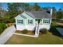 Charming elevated home with stairs to entry, a walkway to the driveway, and manicured landscaping at 4281 Jacobs Point Ct, Ravenel, SC 29470