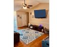 Bright living room featuring a ceiling fan, mounted TV, and a patterned area rug at 429 Stephanie Dr, Goose Creek, SC 29445