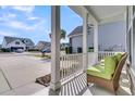 View from the cozy front porch showing a chair and view of neighborhood at 458 Four Seasons Blvd, Summerville, SC 29486