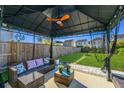 Relaxing backyard featuring a covered patio, outdoor furniture, ceiling fan, and well-maintained lawn at 458 Whispering Breeze Ln, Summerville, SC 29486