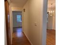 Light and bright hallway featuring hardwood floors and views into adjoining rooms at 5310 Edith St, North Charleston, SC 29418