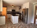 Kitchen with stainless steel appliances, white cabinets, and central island at 5310 Edith St, North Charleston, SC 29418