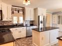 Updated kitchen featuring stainless steel appliances, a center island, and stylish backsplash at 5310 Edith St, North Charleston, SC 29418