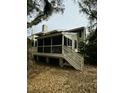 Back porch with railings and stairs surrounded by trees and leaves, offering a private outdoor space at 60 Fairway Dunes Ln, Isle of Palms, SC 29451