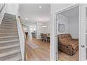 Bright foyer with hardwood floors leads to an open-concept living and dining area at 68 Red Bluff St, Summerville, SC 29483