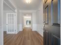 Inviting entryway showcasing wood-look floors, white trim, and a decorative glass door at 8703 Forte Dr, North Charleston, SC 29406