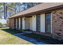 Brick-faced home with large shuttered windows, landscaped entrance and sidewalk access at 105 Wade Ct, Summerville, SC 29486